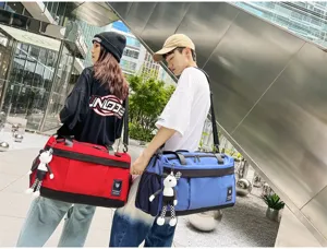 Large capacity travel duffel bag with stylish strap and cute plush pendant for outdoor trips.