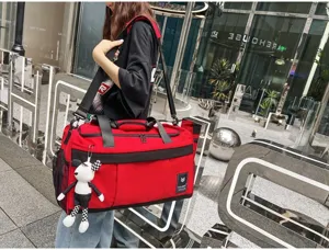 Red travel duffel bag with shoulder strap, large capacity weekend luggage bag for sports and outdoor.