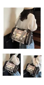 Detailed view of the stylish color-blocked travel shoulder bag with transparent front pocket.
