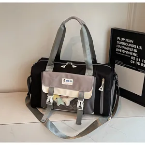 Detailed view of large capacity black and grey contrast travel duffel bag with front clear window.