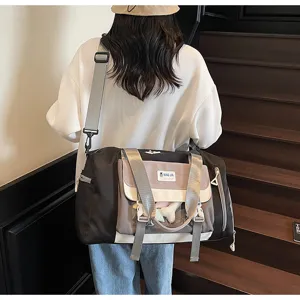 Detail view of the stylish contrast color travel duffel bag with clear front pocket for daily use.