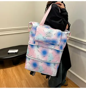 Detail view of the expandable travel tote bag with wheels and space gradient print design.