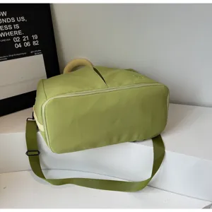 Green solid color travel duffel bag with shoulder strap, ideal for fitness and outdoor trips.