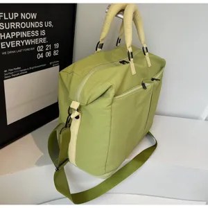 Casual light green travel duffel bag with shoulder strap and front pocket for daily use.