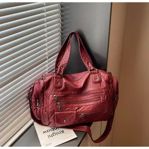 Vintage washed leather multi-zipper motorcycle shoulder bag detail view with roomy design.