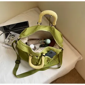 Green travel duffel bag with yellow handles, large capacity gym shoulder bag for women daily use.