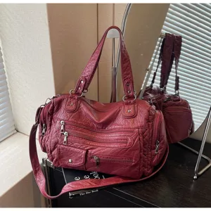 Vintage washed leather shoulder bag with multiple zippers and spacious capacity for use.