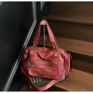 Vintage red washed motorcycle shoulder bag with multi zippers and large capacity for travel.