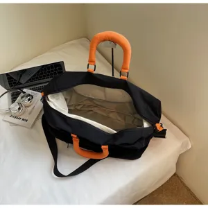 Black and orange travel bag interior detail, spacious compartment, durable fabric style.
