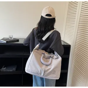 Casual solid color travel duffel bag with shoulder strap, lightweight design for trips.