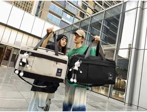 Large capacity travel duffel bag with stylish contrast color design and cute pendant detail.