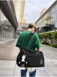 Detail shot of a black travel duffel bag, casual weekend bag with shoulder strap.