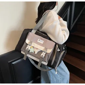 Detail of the stylish color block travel duffel bag showing front clear window and shoulder strap.