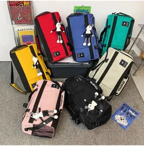 Multifunctional travel duffel bag with cute doll pendant, large capacity weekend luggage.