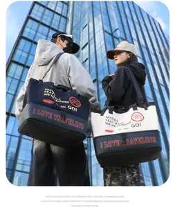 Large capacity travel duffel bag for short trips, gym and sports. Stylish canvas shoulder bag.