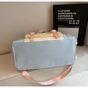 Sweet colorblock travel duffel bag detail, large capacity crossbody luggage bag with pink straps.
