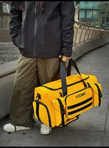 Close-up of bright yellow travel duffel bag with multiple pockets for sports and commuting.