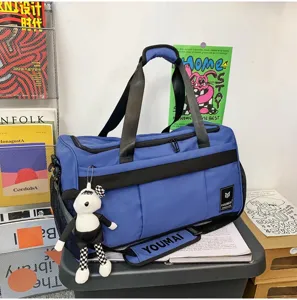 Detailed view of the stylish blue travel duffel bag with durable straps and cute keychain.