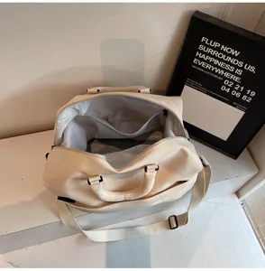 Detailed view of cream travel duffel bag interior, showcasing spacious storage capacity.