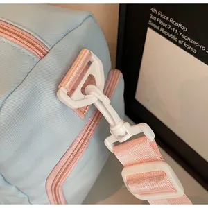 Detailed shot of sweet color-block travel shoulder bag with durable plastic hardware.