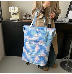Large capacity expandable rolling travel tote bag with universal wheels and stylish printed design for women.
