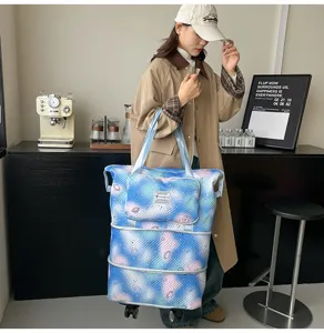 Detail view of the galaxy print expandable rolling travel tote bag with universal wheels.