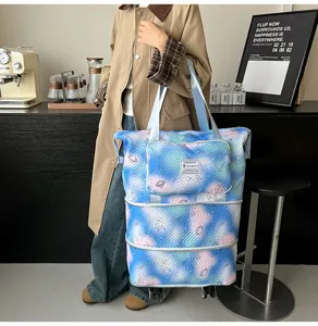 Expandable rolling travel tote bag with large capacity, stylish printed pattern and wheels.