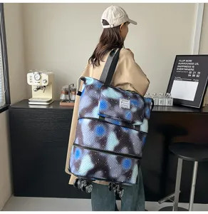 Detailed view of the expandable travel tote bag with universal wheels and galaxy print.