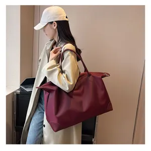 Large capacity travel duffel bag for women, lightweight short trip luggage bag in burgundy.