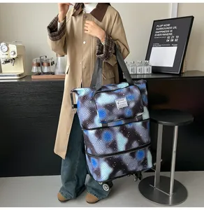 Detailed view of foldable travel tote bag with universal wheels and trendy print.