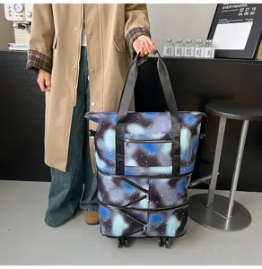 Expandable rolling tote bag detail showing galaxy print, multiple zippers and smooth wheels.