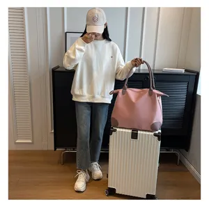 Detailed view of the pink travel duffel bag in a lifestyle setting, great for short trips.