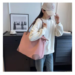 Large capacity pink nylon travel duffel bag for women lightweight weekend luggage for short trips.