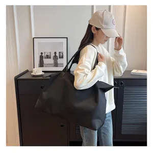 Large capacity black travel tote bag, lightweight nylon duffel for short trips and gym use.