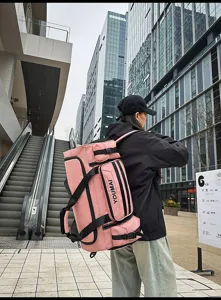 Detail view of the pink multi-pocket travel backpack, showing sturdy straps and functional pockets.