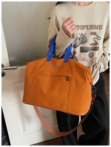 Large capacity travel duffel bag with contrasting blue handles and stylish orange waterproof fabric.