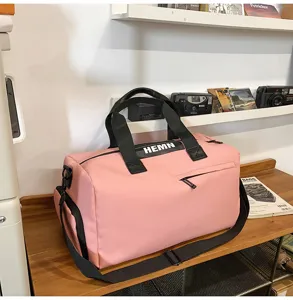 Pink sports duffel bag, large capacity travel luggage bag with shoulder strap, waterproof design.