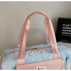 Detailed view of the cute pastel blue and pink travel duffel bag with front pocket design.