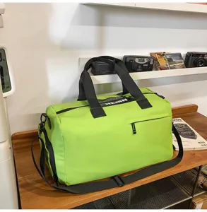 Detail view of large capacity waterproof sports gym duffel bag in green with black straps