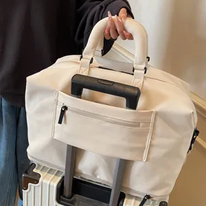 Large capacity travel duffel bag with trolley sleeve and durable handles for short trips.