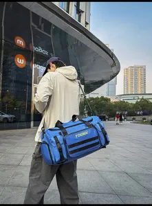 Detailed view of the blue multi-functional travel duffel bag showcasing multiple pockets.