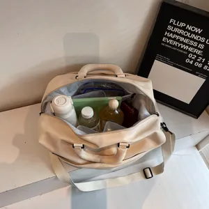 Water-resistant travel duffel bag with large capacity, durable canvas shoulder handbag.