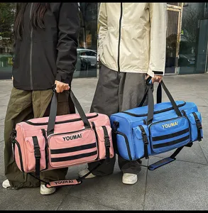Detail of fashionable multi-pocket travel duffel bag showing functional compartments and straps.