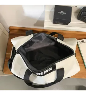 Large capacity waterproof travel duffel bag in white with black straps for outdoor gym use.