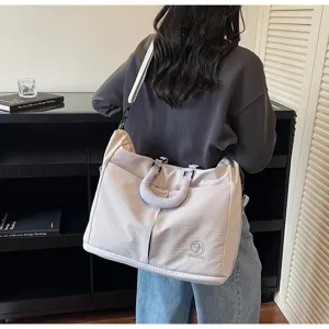 Detailed view of the casual solid color travel duffel bag, featuring sturdy handles.