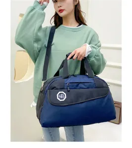 Detailed view of the blue travel duffel bag showcasing front pocket design and durable fabric.