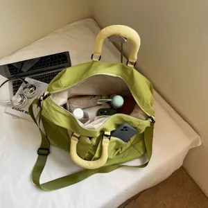 Large capacity green travel duffel bag with yellow handles, perfect for gym and weekend trips.