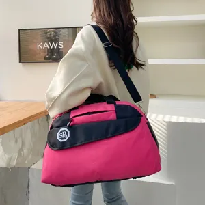 Detailed view of a portable foldable travel luggage bag in pink and black, perfect for trips.