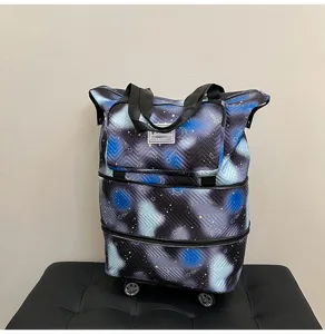 Detailed view of the expandable travel duffel bag with wheels and stylish starry night space print.