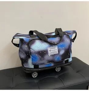 Detailed view of large capacity galaxy print travel duffel bag with universal wheels.